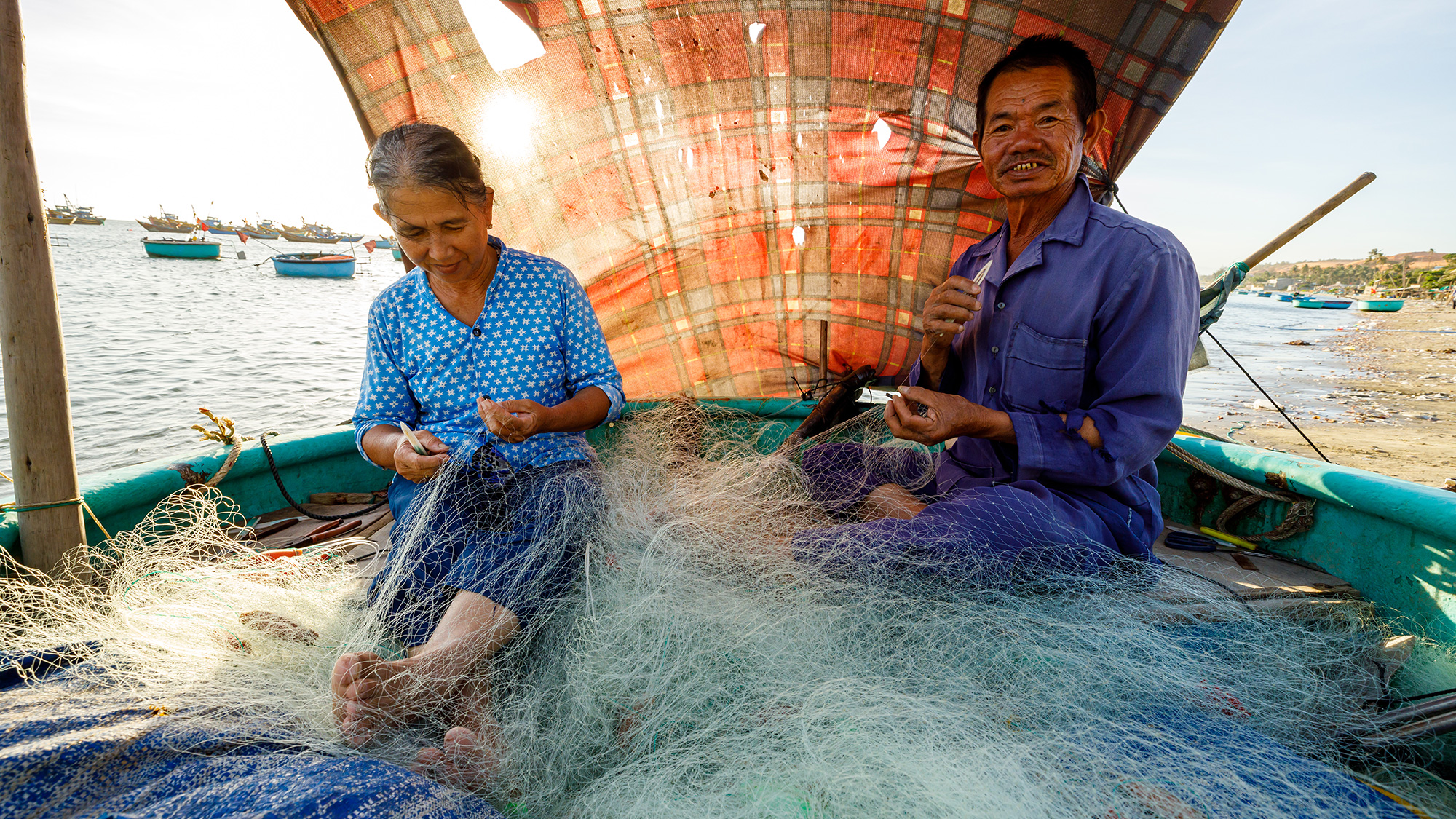 fishers repairing a net